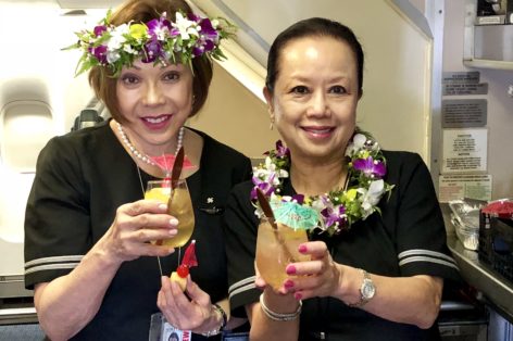 Flight attendants serving pre-departure Mai Tais on the historic flight 